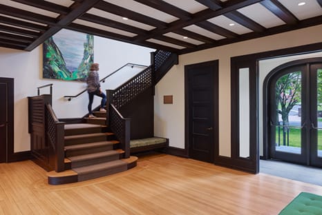 Photo of woman walking up lobby stairs at the Institute of Sacred Music